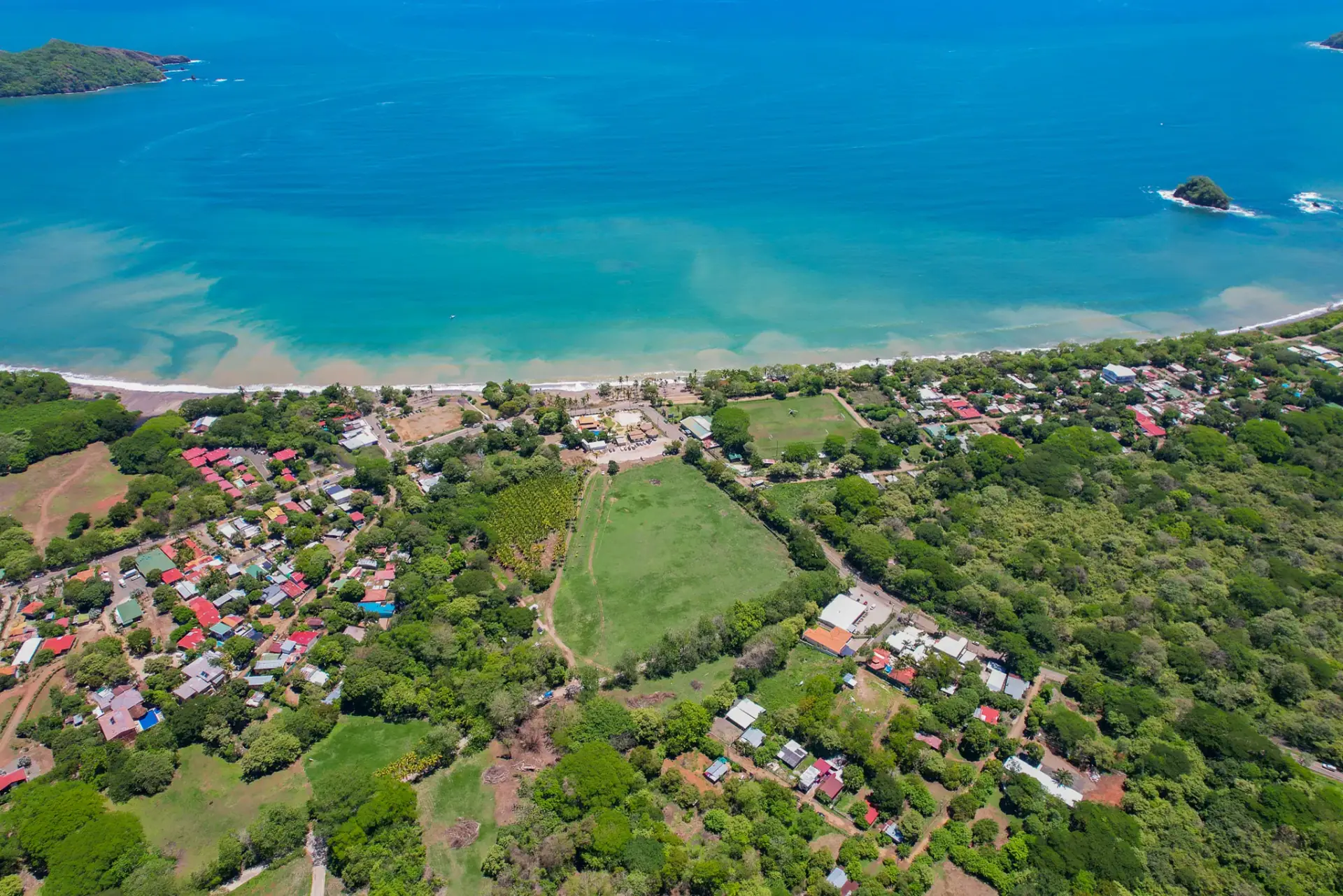 Aerial view of a coastal village on a turquoise bay